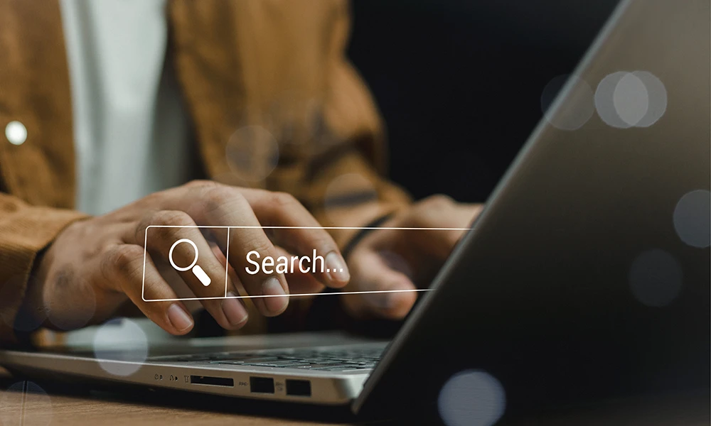 Professional using laptop for Dallas job search with digital search interface overlay | PrideStaff Dallas